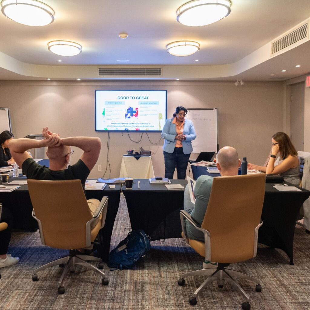 Crystal D’Cunha running a live training session with a team around a boardroom table